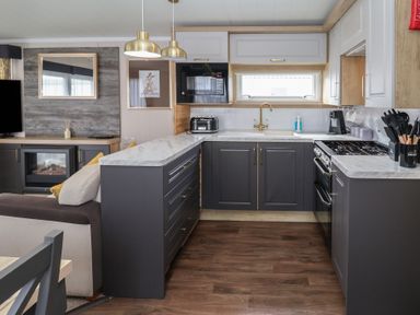 A kitchen with modern appliances at Stag Lodge, Caravan 70, Great Yarmouth