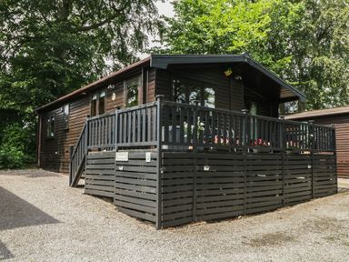 A cabin with a deck and parking area at Watendlath in Keswick