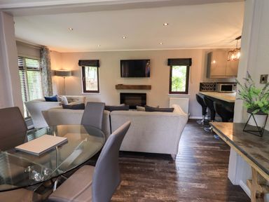 A living room with television and seating area at Costapacket Grasmere 12, White Cross Bay near Windermere
