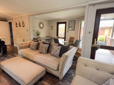 A living room with a sofa and a table at Costapacket Grasmere 12, White Cross Bay near Windermere