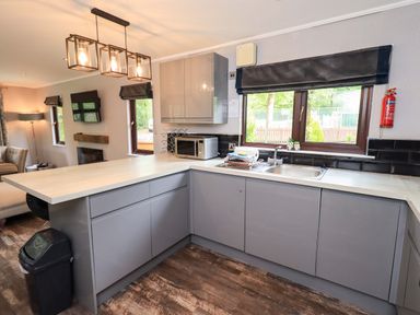 A kitchen with cabinets and a sink at Costapacket Grasmere 12, White Cross Bay near Windermere