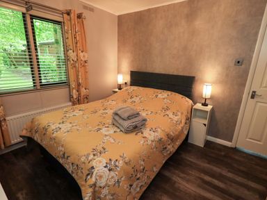 A bedroom with a bed and towels at Costapacket, Grasmere 12, White Cross Bay near Windermere
