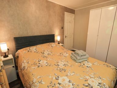 A bedroom with a bed and bedside lamps at Costapacket, Grasmere 12, White Cross Bay near Windermere