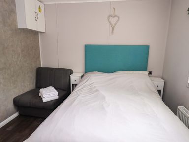 A bedroom with a bed and sofa at Costapacket, Grasmere 12, White Cross Bay near Windermere
