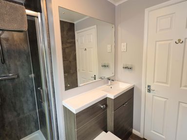 A bathroom with a shower and vanity unit at Costapacket, Grasmere 12, White Cross Bay near Windermere