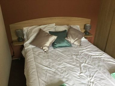 a bed with pillows and bedside lamps in a room at Waterside, Paignton - Holiday Accommodation 10036, Paignton