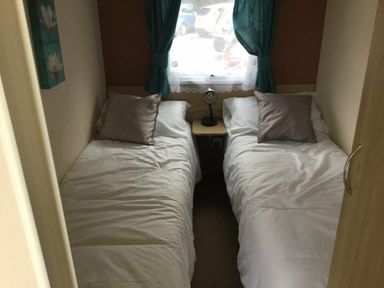 a bedroom with two single beds and a bedside table at Waterside, Paignton - Holiday Accommodation 10036, Paignton