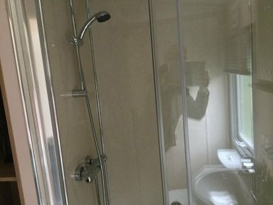 a shower area with a showerhead and glass enclosure at Waterside, Paignton - Holiday Accommodation 10036, Paignton