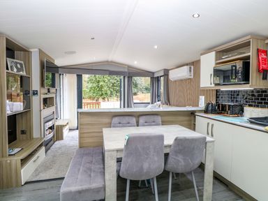 A kitchen with dining area and appliances at Wild Duck Holiday Park in Belton, Norfolk