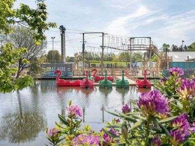 a lake with pedal boats and a ropes course area at Hafan y Mor Haven - Holiday Accommodation 11370 Pwllheli