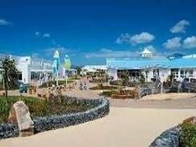 an outdoor area with buildings and landscaping at Hafan y Mor Haven - Holiday Accommodation 11370 in Pwllheli