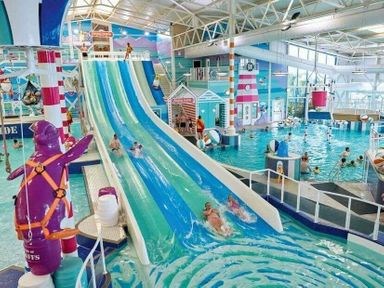 a water park featuring a large water slide and multiple pools at Hafan y Mor Haven - Holiday Accommodation 11370 in Pwllheli