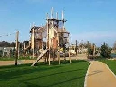 a wooden playground structure with climbing elements at Hafan y Mor Haven - Holiday Accommodation 11370 in Pwllheli
