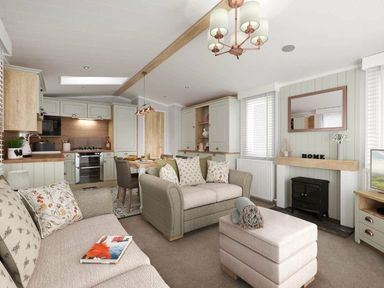 a living room with a sofa, dining area, and kitchen at Perran Sands - Holiday Accommodation 12174 in Perranporth