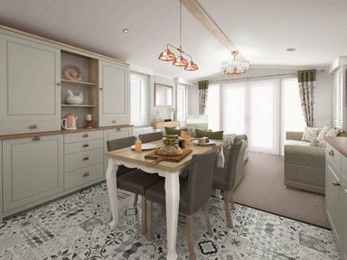 a dining area with a table and chairs, a kitchen cabinet, and a sofa at Perran Sands - Holiday Accommodation 12174 in Perranporth