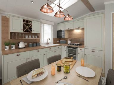 a kitchen with green cabinets and a wooden table at Perran Sands - Holiday Accommodation 12174, Perranporth