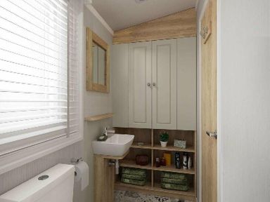 a bathroom with a sink, storage cabinets, and a toilet at Perran Sands - Holiday Accommodation 12174, Perranporth