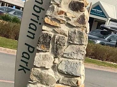 a stone sign with the text 'Cambrian Park' in front of a building at Hafan y Mor Haven - Holiday Accommodation 12637 Pwllheli