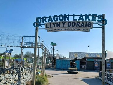a sign for Dragon Lakes Adventure Village with an entrance area at Hafan y Mor Haven - Holiday Accommodation 12637 Pwllheli