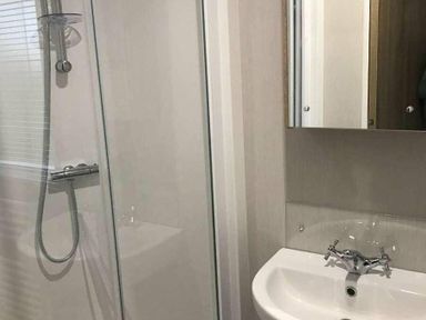 a bathroom with a shower and a sink at Kelling Heath Holiday Park - Holiday Accommodation 13133 in Holt