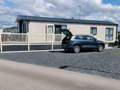 a holiday home with a car parked outside at Ocean Edge Leisure Park - Holiday Accommodation 1317 Heysham