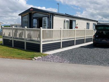 a holiday home with a deck and gravel parking at Ocean Edge Leisure Park - Holiday Accommodation 1317 Heysham