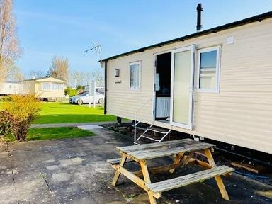 a caravan with a picnic table outside at Butlins Minehead - Holiday Accommodation 13288 in Minehead