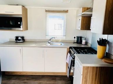 a kitchen with cabinets, a sink, and a stove at Butlins Minehead - Holiday Accommodation 13288, Minehead