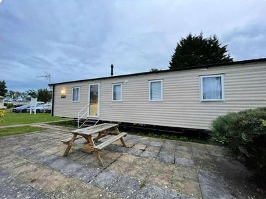 a mobile home with a picnic table in front at Butlins Minehead - Holiday Accommodation 13288 in Minehead