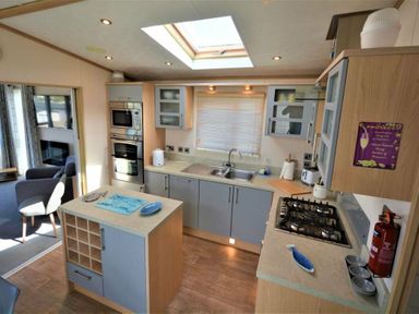 a kitchen with cabinets and appliances at Perran Sands - Holiday Accommodation 15012 in Perranporth