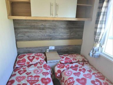 a bedroom with two beds with heart-patterned bedding at Perran Sands - Holiday Accommodation 15554 Perranporth