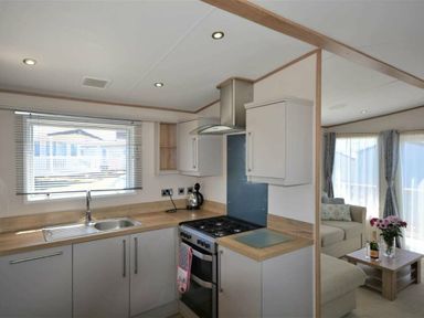 a kitchen area with a sink and stove at Perran Sands - Holiday Accommodation 15598 in Perranporth