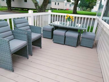 a patio with seating and a table at Hafan y Mor Haven - Holiday Accommodation 15817 in Pwllheli
