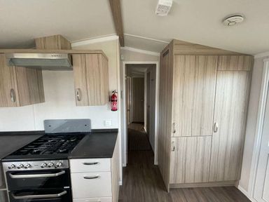 a kitchen area with cabinets and a stove at Unity Holiday Resort - Holiday Accommodation 15970 Brean Sands