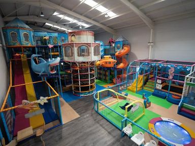 an indoor play area with slides, climbing structures, and colorful toys at Unity Holiday Resort - Holiday Accommodation 15970 in Brean Sands