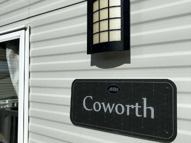 a wall sign with the name Coworth and a light fixture at Newquay Bay Resort - Holiday Accommodation 15978 in Newquay