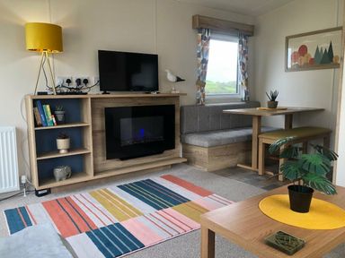 a living room with furniture and a TV at Newquay Bay Resort - Holiday Accommodation 15978 Newquay
