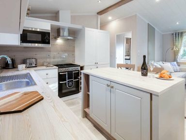 a kitchen with an island and appliances at Kelling Heath Holiday Park - Holiday Accommodation 16221, Holt