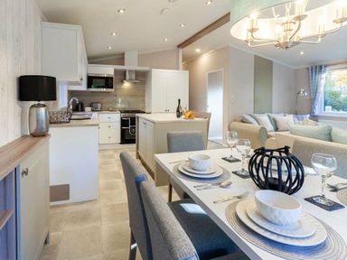 a kitchen and dining area with a table set for dining at Kelling Heath Holiday Park - Holiday Accommodation 16221, Holt