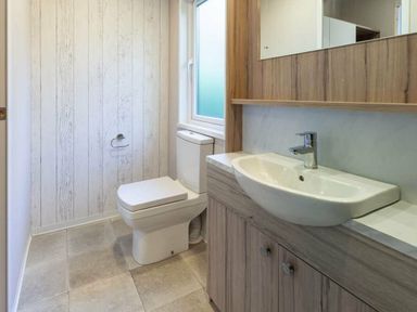 a bathroom with a toilet and sink in Kelling Heath Holiday Park - Holiday Accommodation 16221, Holt