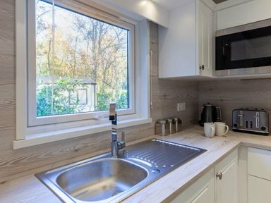 a kitchen sink with a window and appliances at Kelling Heath Holiday Park - Holiday Accommodation 16221, Holt