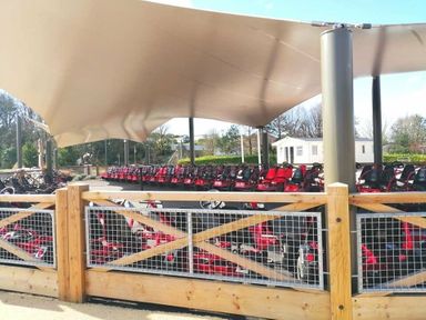 a row of red go-karts under a canopy at Hafan y Mor Haven - Holiday Accommodation 16279 Pwllheli