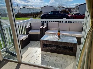 a terrace with seating and a table at Unity Holiday Resort - Holiday Accommodation 16507, Brean, Somerset, United Kingdom