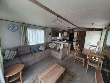 a living room with a sofa, coffee table, and dining area at Unity Holiday Resort - Holiday Accommodation 16507, Brean, Somerset, United Kingdom