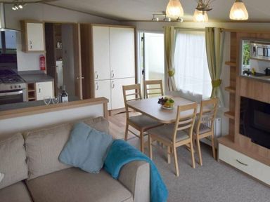 a kitchen and dining area with a table and chairs at Unity Holiday Resort - Holiday Accommodation 16507 Brean, Somerset, United Kingdom