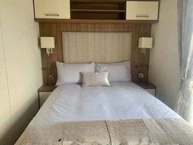 a bedroom with a double bed and bedside lights at Unity Holiday Resort - Holiday Accommodation 16507, Brean, Somerset, United Kingdom