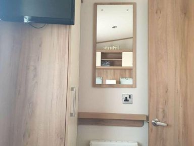 a room with a mirror and shelf near a door at Unity Holiday Resort - Holiday Accommodation 16507, Brean, Somerset, United Kingdom