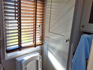 a bathroom with window blinds and a cabinet at Lakeland Leisure Park - Holiday Accommodation 16942 in Flookburgh