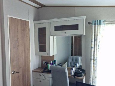 a dressing area with a mirror and drawers at Lakeland Leisure Park - Holiday Accommodation 16942 in Flookburgh