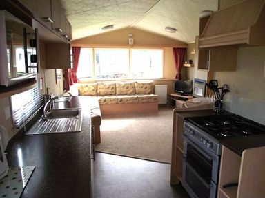 a kitchen and living area with a couch and television at Butlins Minehead - Holiday Accommodation 1700 in Minehead